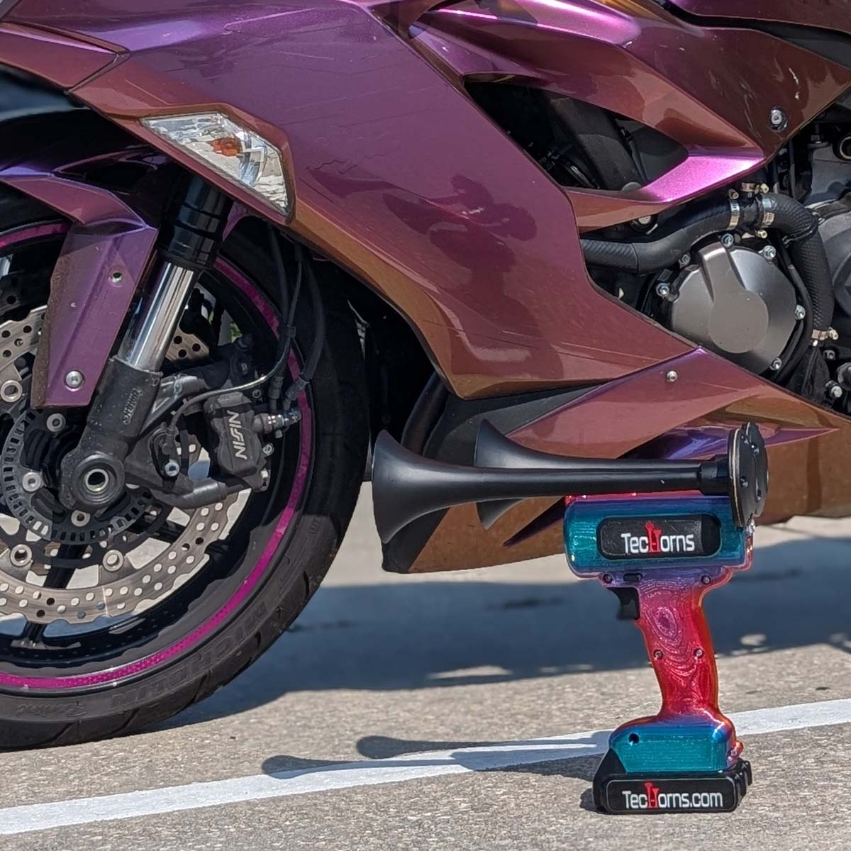 TecHorns Fire & Ice Candy 2-Horn – 130 dB handheld train horn with 20 V lithium battery, shown with a matching custom streetbike featuring red and blue accents