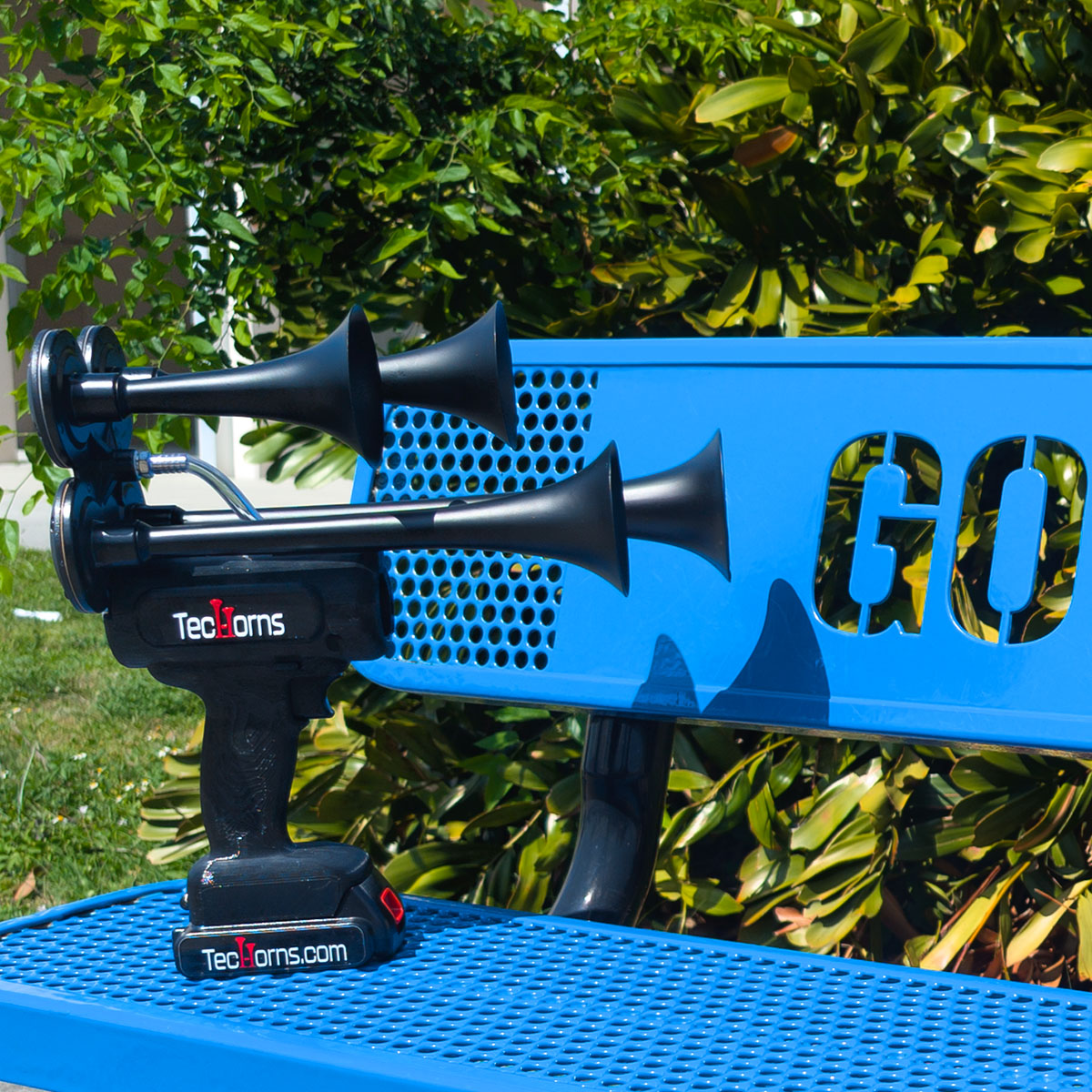 TecHorns Satin Black 4-Horn – 130 dB compact handheld train horn with 20V lithium battery and charger, displayed on a blue GO bench