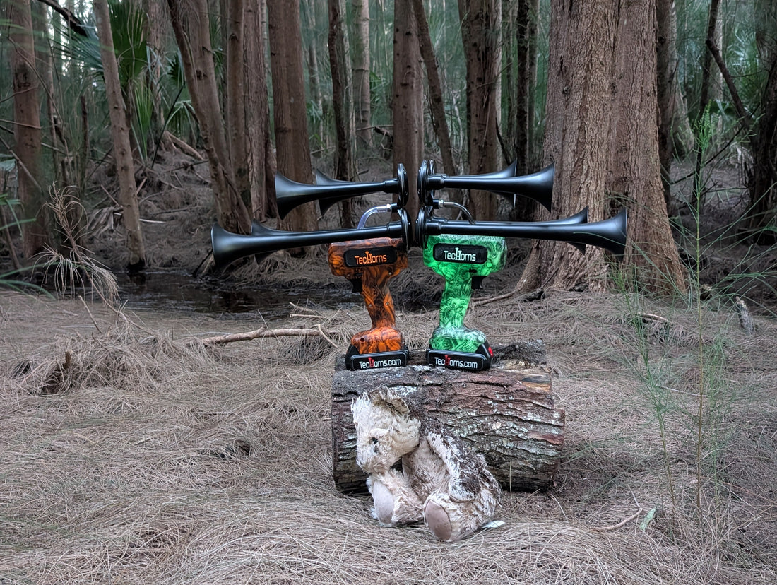 Abandoned teddy bear and twin TecHorns sit quietly on a log in the dark woods. It's a haunting Halloween setup that feels straight out of a horror movie.