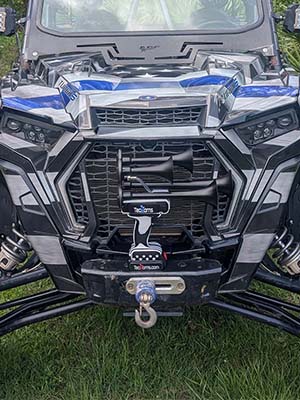 Thin BLUE Line TecHorn 4-Horn handheld train horn with 20 V lithium battery displayed on the winch of a Thin BLUE Line wrapped UTV, representing power, pride, and support for first responders