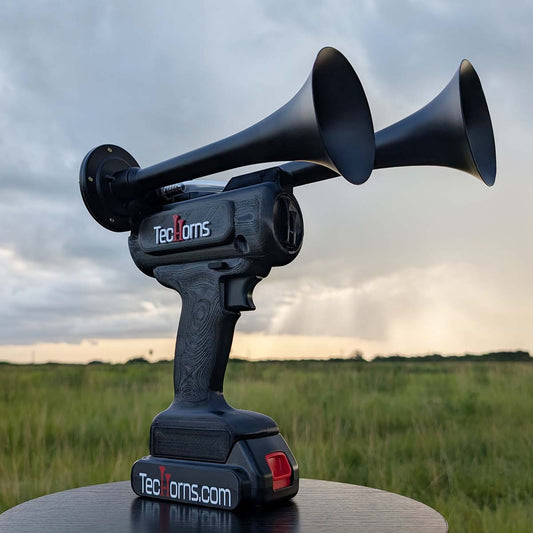 TecHorns Satin Black 2-Horn – 130 dB handheld train horn with 20V lithium battery, shown with storm backdrop for powerful dramatic effect