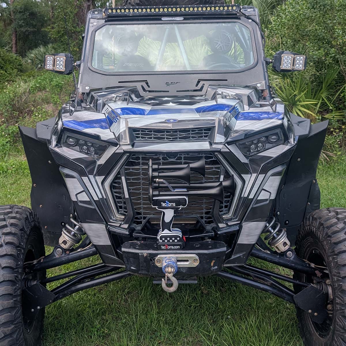 Thin BLUE Line TecHorns 4-Horn – handheld train horn with 20 V lithium battery, displayed on the bumper of a Thin BLUE Line wrapped side-by-side vehicle