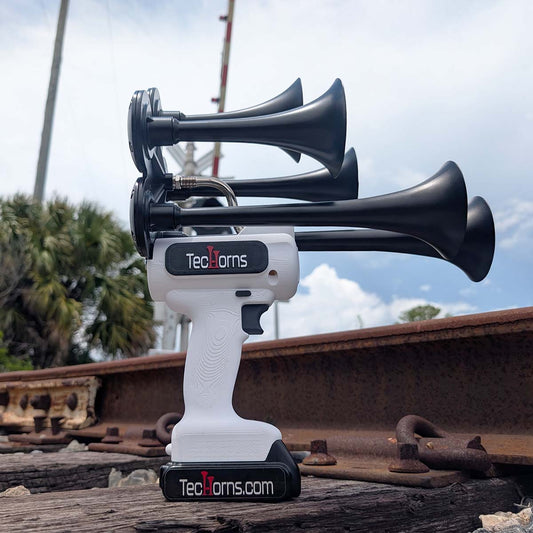 TecHorns White 5-Horn – single color handheld train horn, 130 dB deep-tone with 20V lithium battery, photographed at railroad track and crossing